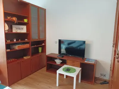 a living room with a tv and a table at Sweet home apartment Kobylisy in Prague