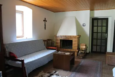 a living room with a couch and a fireplace at Chalupa Všetice in Netvořice