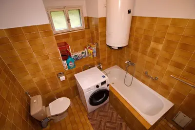 a bathroom with a sink and a washing machine at Chalupa Všetice in Netvořice