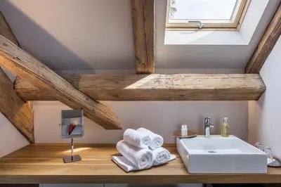 a bathroom with a sink and towels on a wooden counter at Yard Resort in Předboj