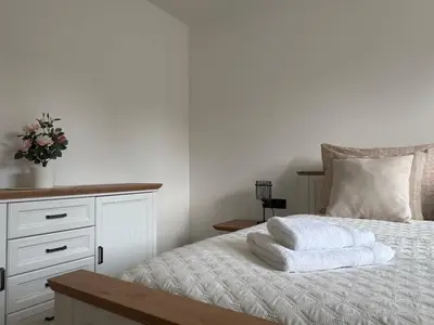 a bed with two towels on top of it at Home by the Pool & Garden in Srbín