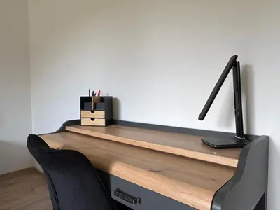 an office desk with a black lamp and two chairs at Home by the Pool & Garden in Srbín