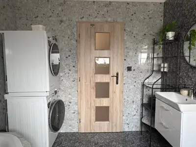 a kitchen with a white refrigerator and a sink at Home by the Pool & Garden in Srbín