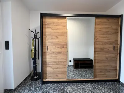 a large wooden door with a mirror in a room at Home by the Pool & Garden in Srbín