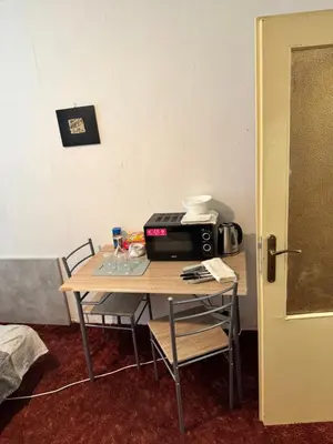 a small table with a microwave on top of it at Lužiny in Prague