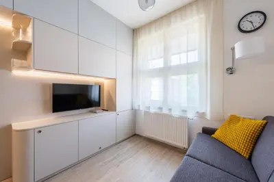 a living room with a couch and a tv and a window at Urban Hideaway in Prague