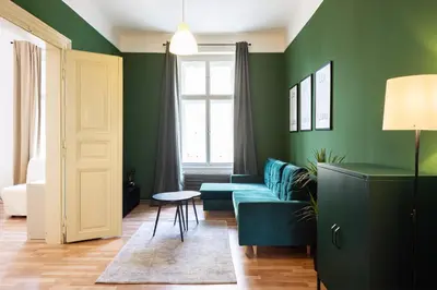 a living room with green walls and a blue couch at Masaryk Lounge in Prague