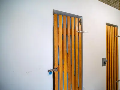 a wooden door in a room with a wall at Apartmán Ve středu dění in Poděbrady