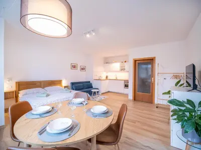 a living room with a table and a bed at Apartmán Ve středu dění in Poděbrady