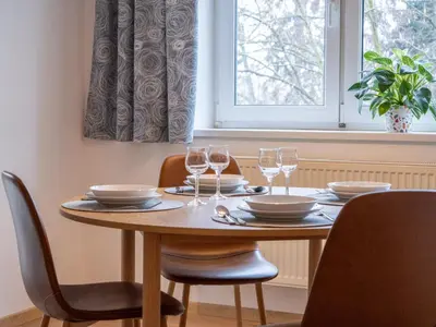 a dining room table with chairs and glasses on it at Apartmán Ve středu dění in Poděbrady