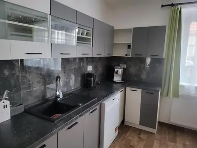 a kitchen with white cabinets and a sink at Ubytování U100bodů za švestkovou dráhou