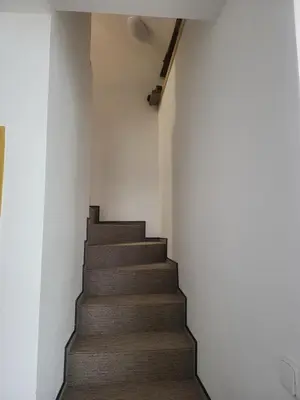 a staircase in a room with white walls at Ubytování U100bodů za švestkovou dráhou