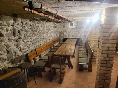 a long wooden table and benches in a room at Ubytování U100bodů za švestkovou dráhou