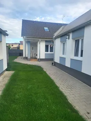 a house with a green lawn in front of it at Ubytování U100bodů za švestkovou dráhou
