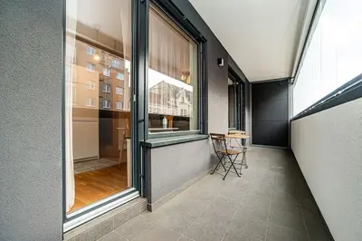 a hallway with a large window and a table at Spacious studio with free parking in Prague