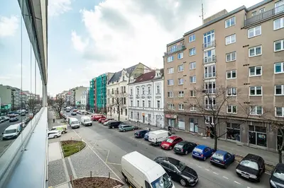 a view of a city street with cars parked at Spacious studio with free parking in Prague