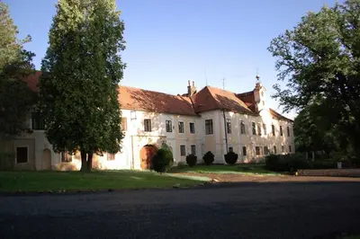 a large white building with a red roof at Suite at Château Domoušice in Domoušíce