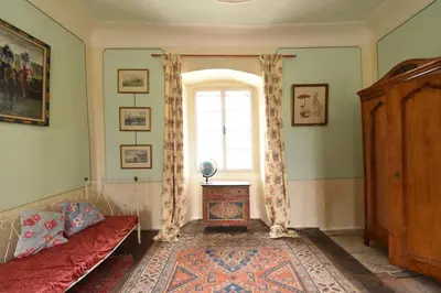 a living room with a couch and a window at Suite at Château Domoušice in Domoušíce