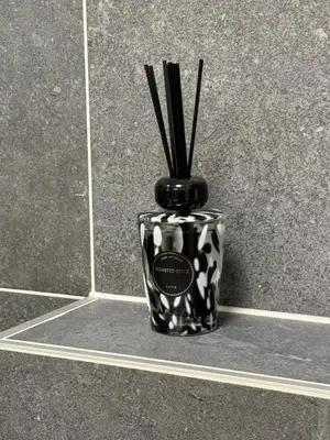 a black and white vase with sticks in it at Kubánské náměstí in Prague