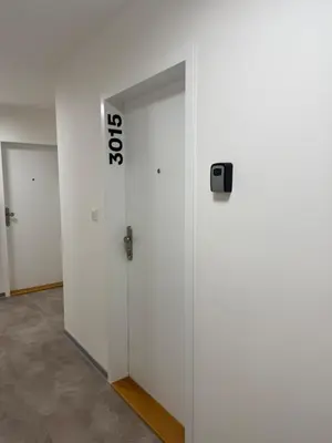 a white elevator with a door with a sign on it at Kubánské náměstí in Prague