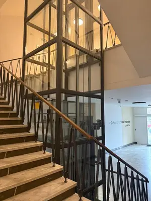 a staircase in a building with glass at Kubánské náměstí in Prague