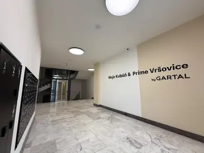 a hallway with a sign on a wall in a building at Kubánské náměstí in Prague
