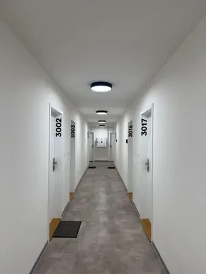 a hallway with white doors at Kubánské náměstí in Prague