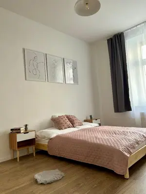 a bedroom with a bed and a window at Centre Apartment by the River in Prague