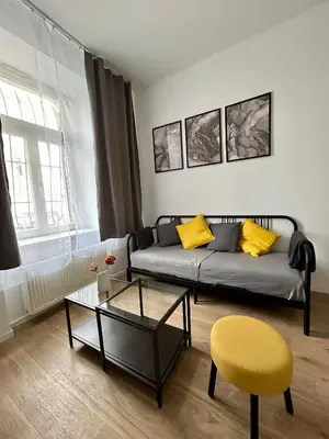 a living room with a couch and a table at Centre Apartment by the River in Prague