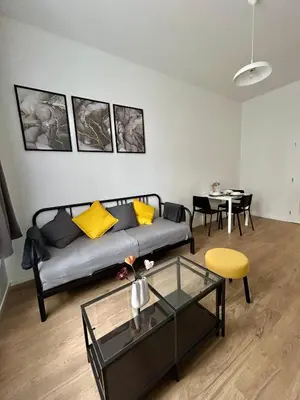 a living room with a couch and a table at Centre Apartment by the River in Prague