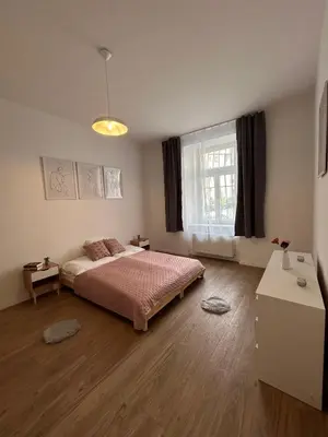 a bedroom with a bed and a window at Centre Apartment by the River in Prague