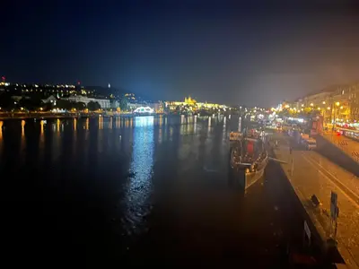 a view of a river at night with boats in the water at Centre Apartment by the River in Prague