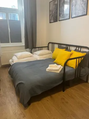a bedroom with two beds with yellow pillows at Centre Apartment by the River in Prague