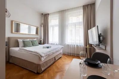 a hotel room with a bed and a table and a tableablish at Zen Garden in Prague
