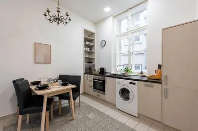 a kitchen with a table and a washing machine at Zen Garden in Prague