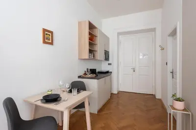 a small kitchen with a table and chairs in a room at Zen Garden in Prague