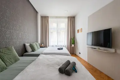 a hotel room with two beds and a flat screen tv at Zen Garden in Prague