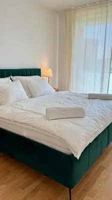 a large bed in a room with a window at Spacious urban apartment with terrace in Prague