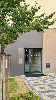 a building with a glass door and a tree at Spacious urban apartment with terrace in Prague
