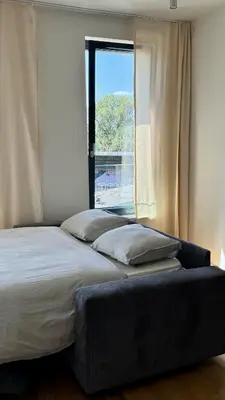 two beds in a room with a window at Spacious urban apartment with terrace in Prague