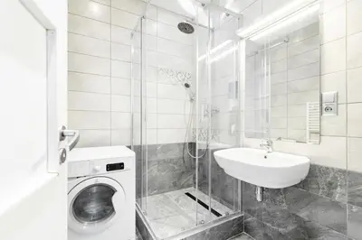 a bathroom with a sink and a washing machine at Rentero Central Two Bedroom Apartment in Prague - Two bathroom - Parking in Prague