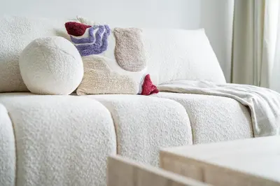 a white couch with blankets and pillows on it at Rentero Central Two Bedroom Apartment in Prague - Two bathroom - Parking in Prague