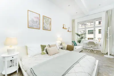 a white living room with a couch and a table at Rentero Central Two Bedroom Apartment in Prague - Two bathroom - Parking in Prague