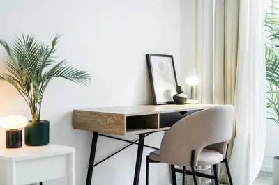 a desk with a chair in a room with a plant at Rentero Central Two Bedroom Apartment in Prague - Two bathroom - Parking in Prague
