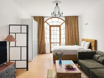 a living room with a bed and a couch at Beautiful OLD TOWN penthouse in Prague