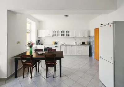 a kitchen with a dining room table and chairs at Beautiful OLD TOWN penthouse in Prague
