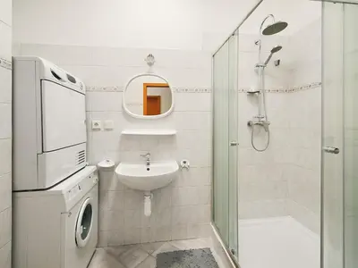 a white bathroom with a sink and a shower at Beautiful OLD TOWN penthouse in Prague