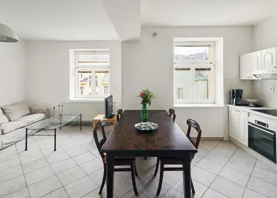 a kitchen and living room with a table and chairs at Beautiful OLD TOWN penthouse in Prague