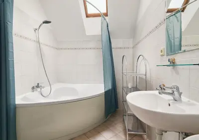 a bathroom with a tub and a sink at Beautiful OLD TOWN penthouse in Prague