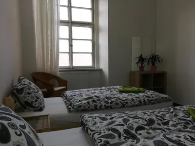 two beds in a room with a window at Just 3 min Walk Old Town Center private room A in Prague